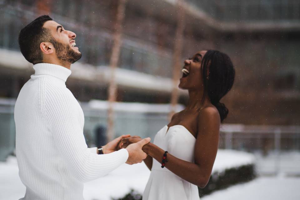 Couple standing in the snow at their 3,000 wedding dancing outdoors