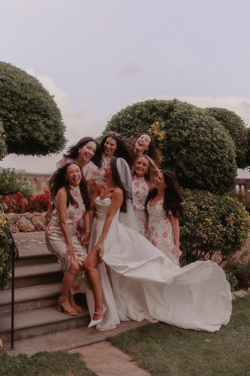 Josie in her pronovias wedding dress surrounded by her bridesmaids wearing Rixo
