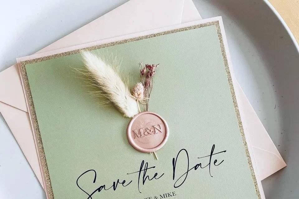 Sage save the date with dried flowers and a cream envelope