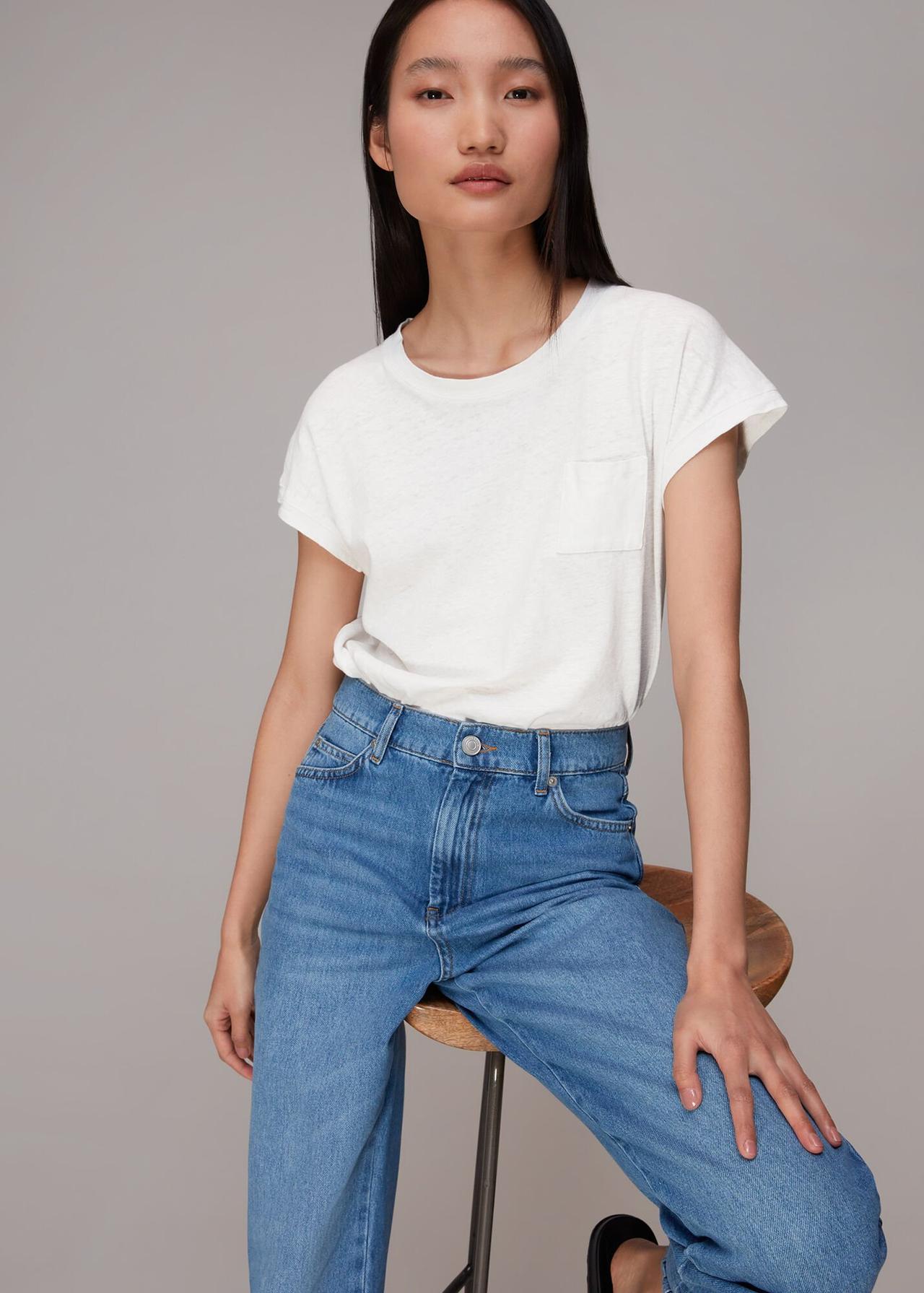 Model wearing a white tee with blue jeans