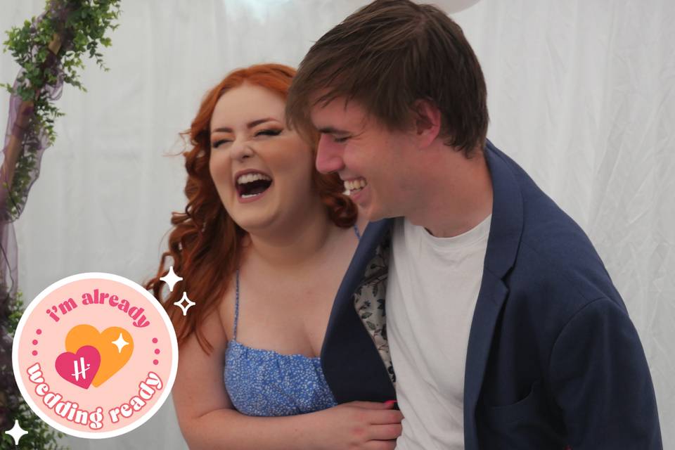 Influencer Lucy Edwards and her fiance Ollie laughing against a white background with the Hitched Already Wedding Ready badge in the bottom left