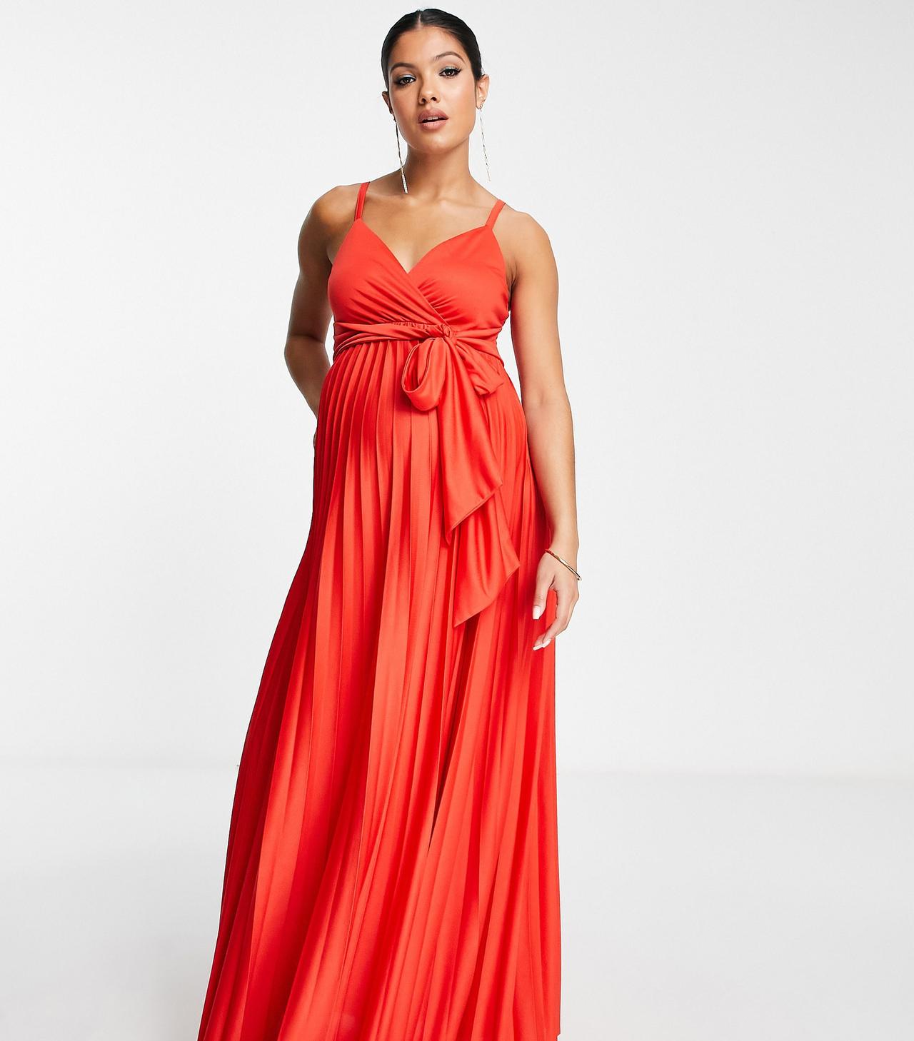 Model wearing a red pleated maternity bridesmaid dress