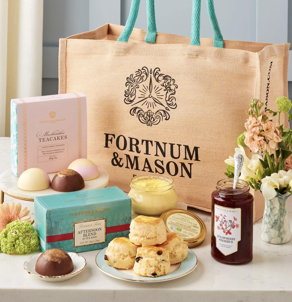 canvas fortnum & mason's bag full of cream tea hamper items like tea cakes, tea and biscuits