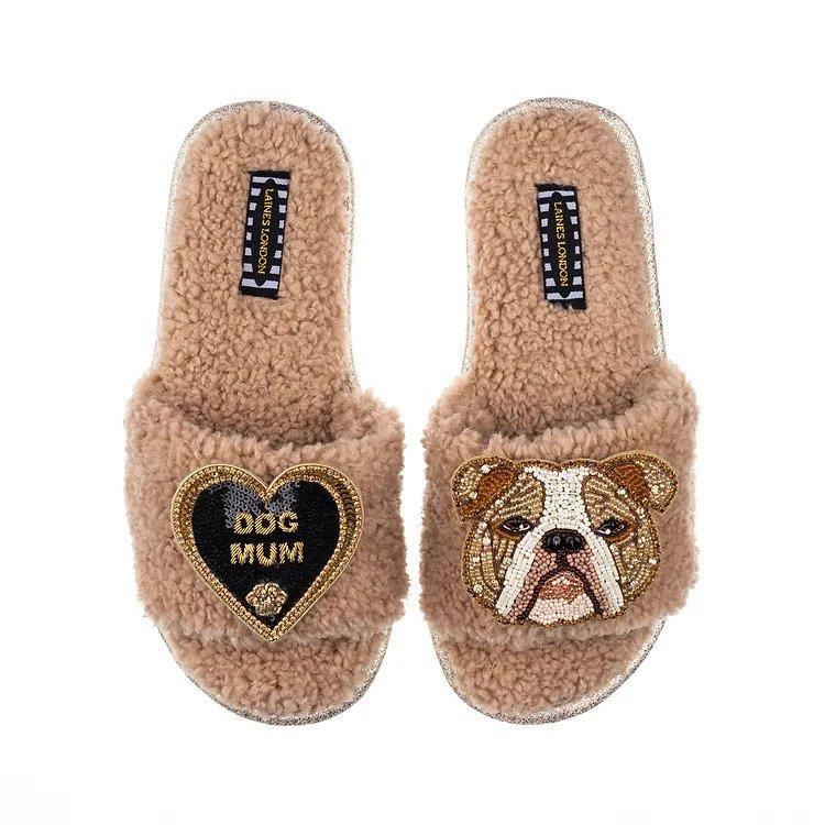 Fluffy fleece textured slippers with a brooch saying 'dog mum' on one side in a heart, and a beaded brooch of a bull dog's face on the other