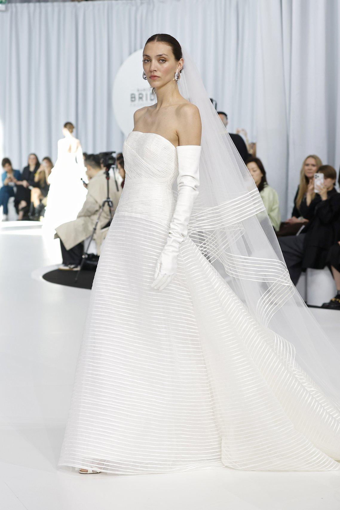 bride modelling Peter Langner on the runway for Barcelona Bridal Week, styling a stripy veil 