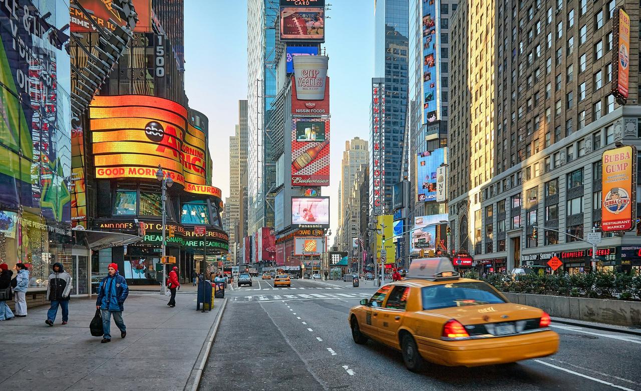 A yellow taxi driving through New York City.