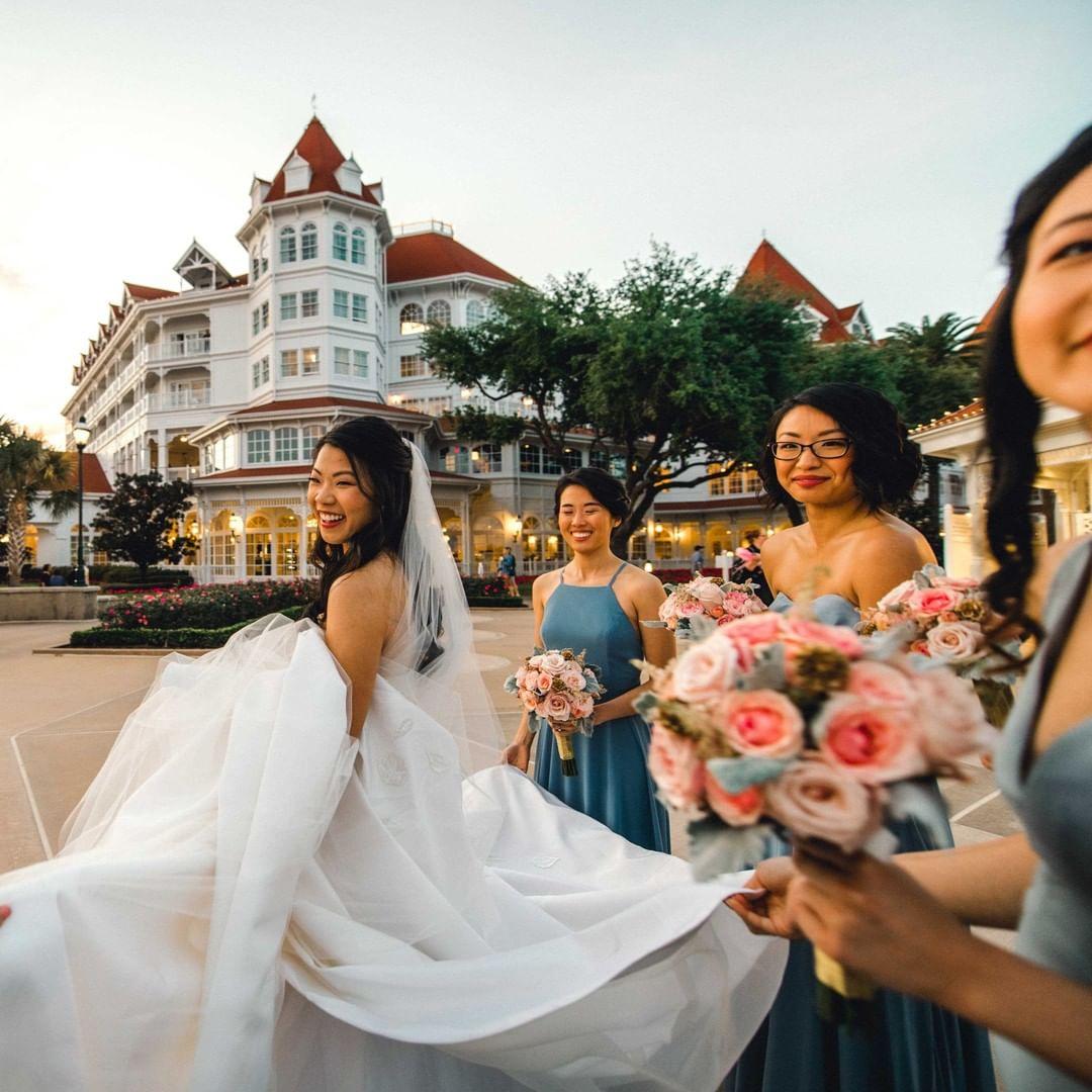 A bride and her three bridesmaids walking through Disney World