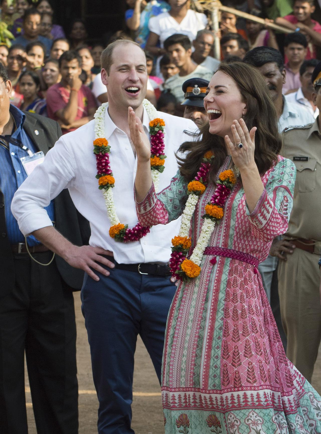 Kate Middleton and Prince William laugh as they play football together