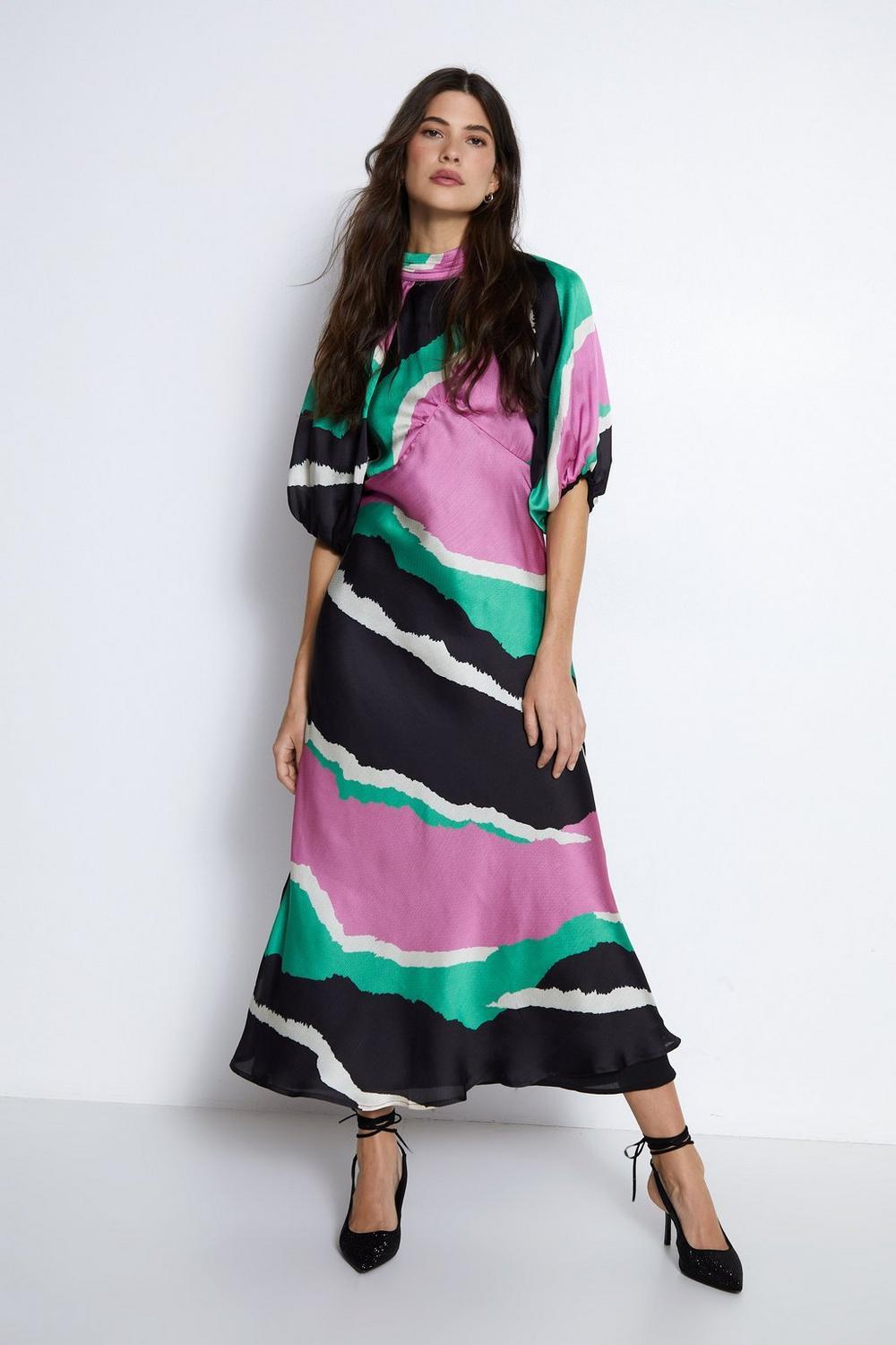 Model wearing a colour block puff sleeve dress