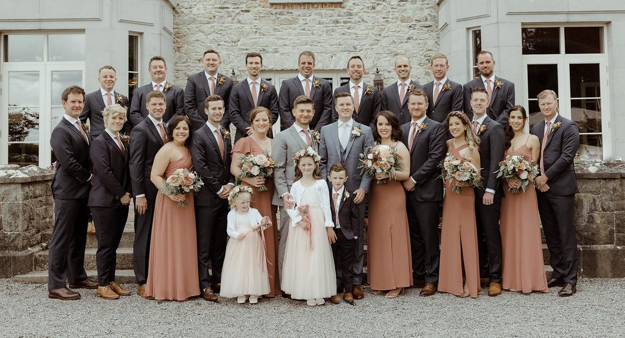 The grooms pose with their wedding party