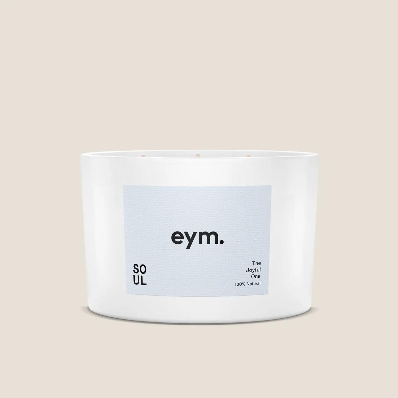 A large white candle with a pale blue label that reads: 
