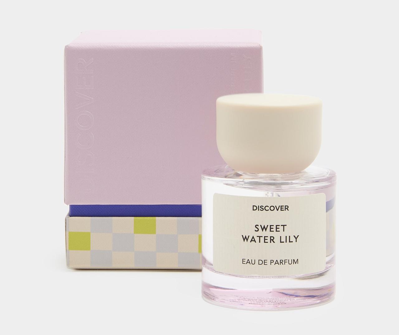 A bottle of Marks and Spencer Sweet Water Lily Perfume with sculptural lid next to its colourful box packaging.