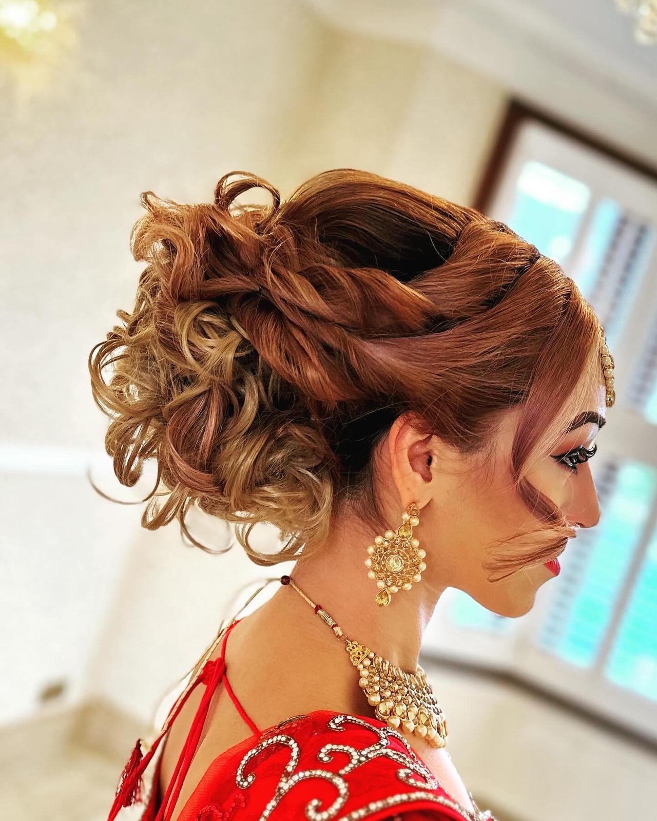 An Indian Bride with a curled updo on her wedding day
