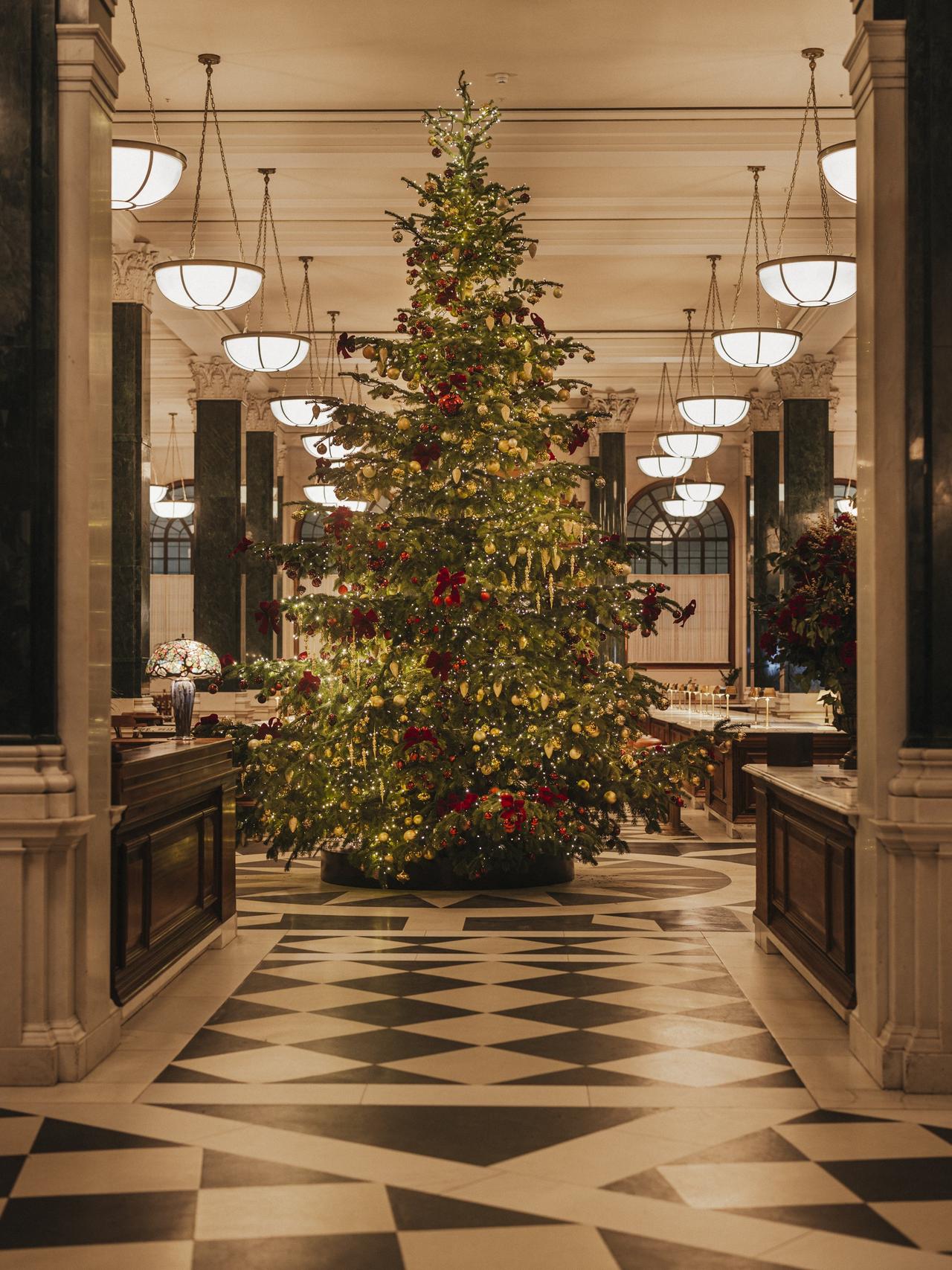 a large decorated Christmas tree pictured inside The Ned, London