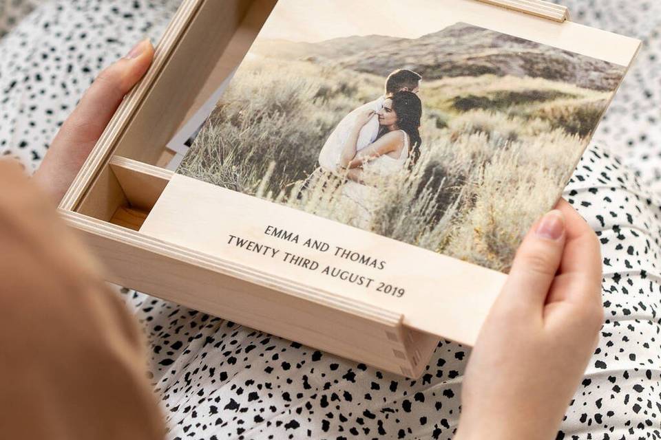 A wooden photo box with a photo of the couple, their names, and their wedding date