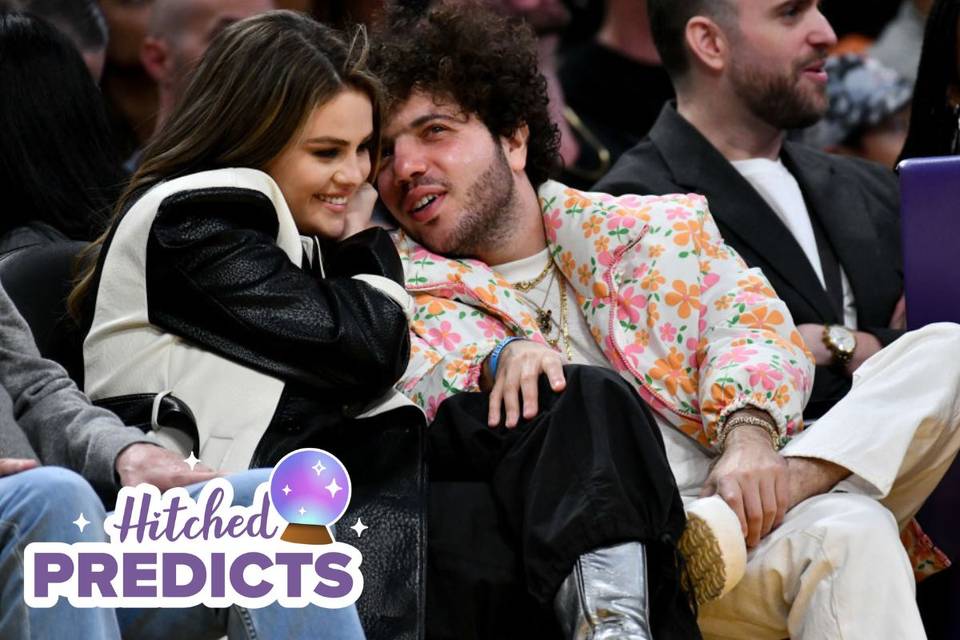 Selena Gomez and Benny Blanco cuddling and talking at a basketball game in a crowd of people