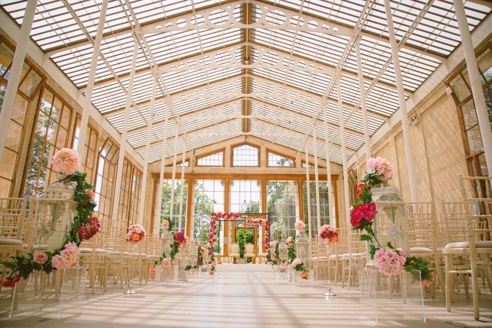 Wedding aisle decorated with pink and red flowers