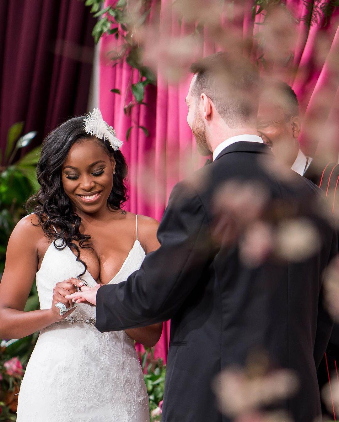 love is blind episode showing lauren putting a ring on cameron's finger at their wedding day