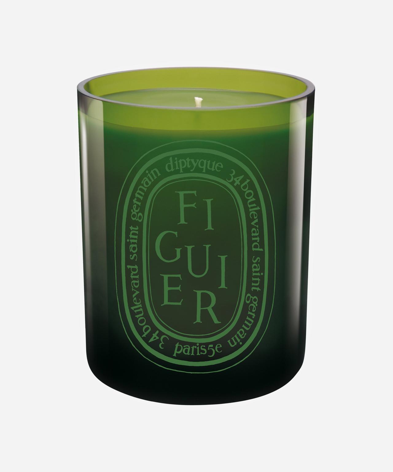 Glossy green candle that reads 