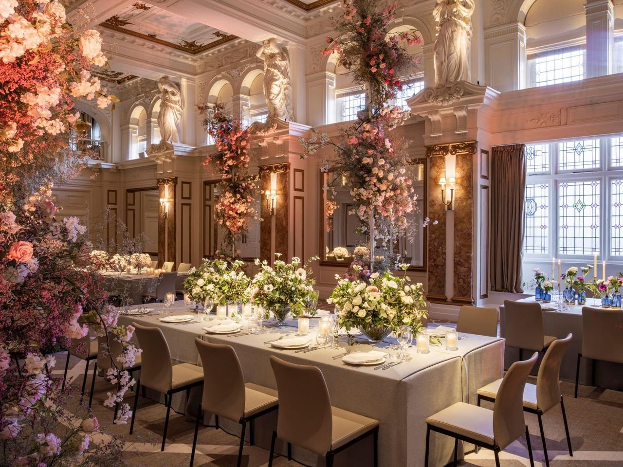 a beautiful stately home hotel dining room decorated in colourful flowers at the Kimpton Fitzroy hotel