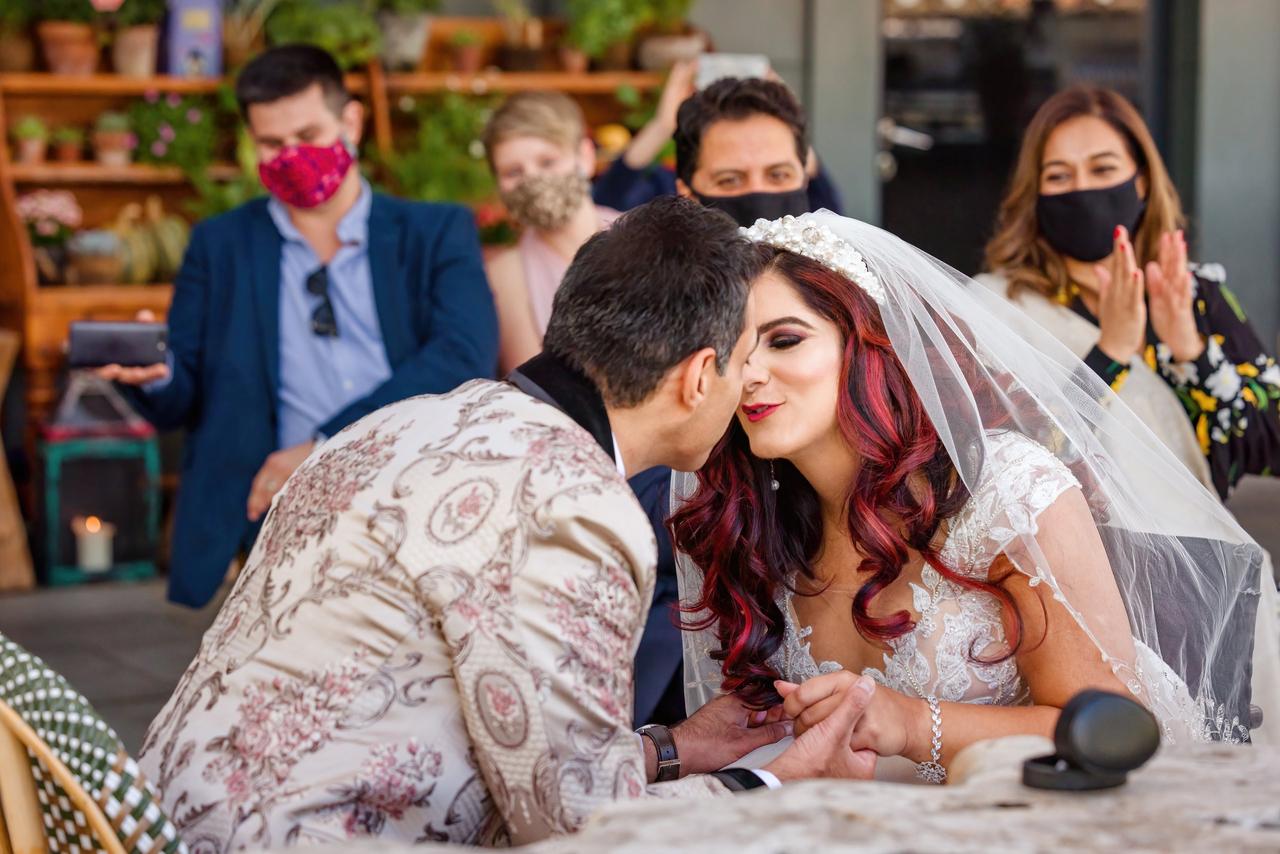 Nurani and Sam kissing at their wedding ceremony