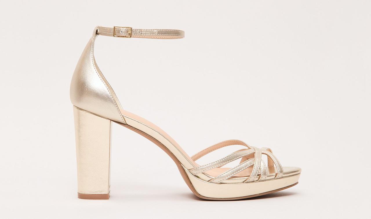 A light gold wedding sandal with a platform heel.