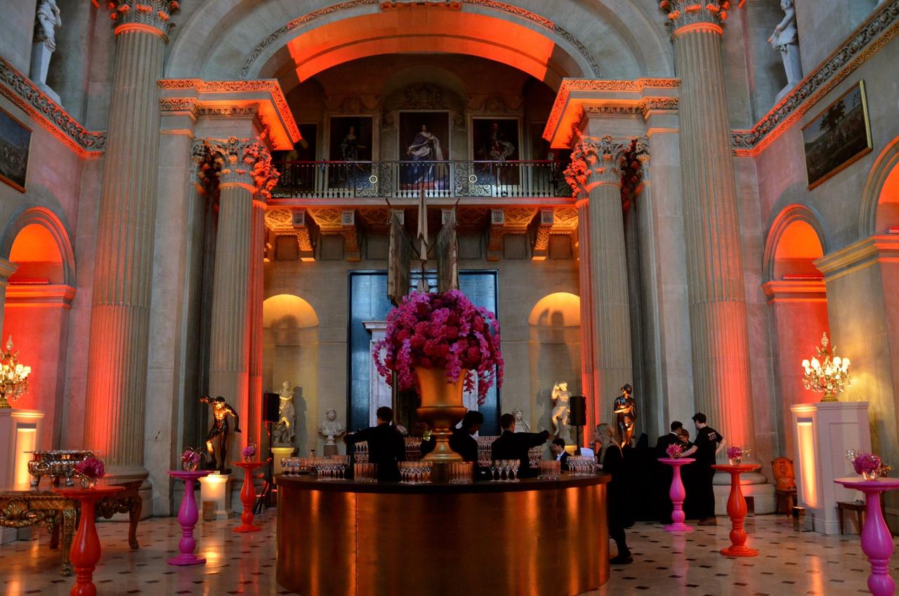 Interior of a palace wedding venue lit up with colourful LED lights.