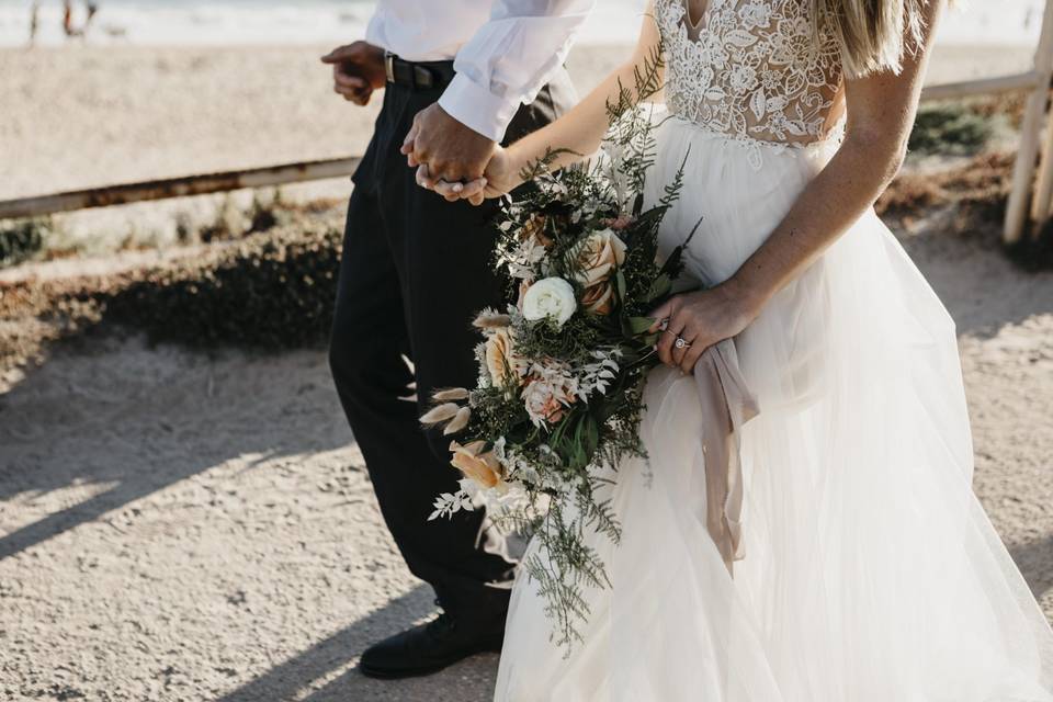 Bride and groom holding hands