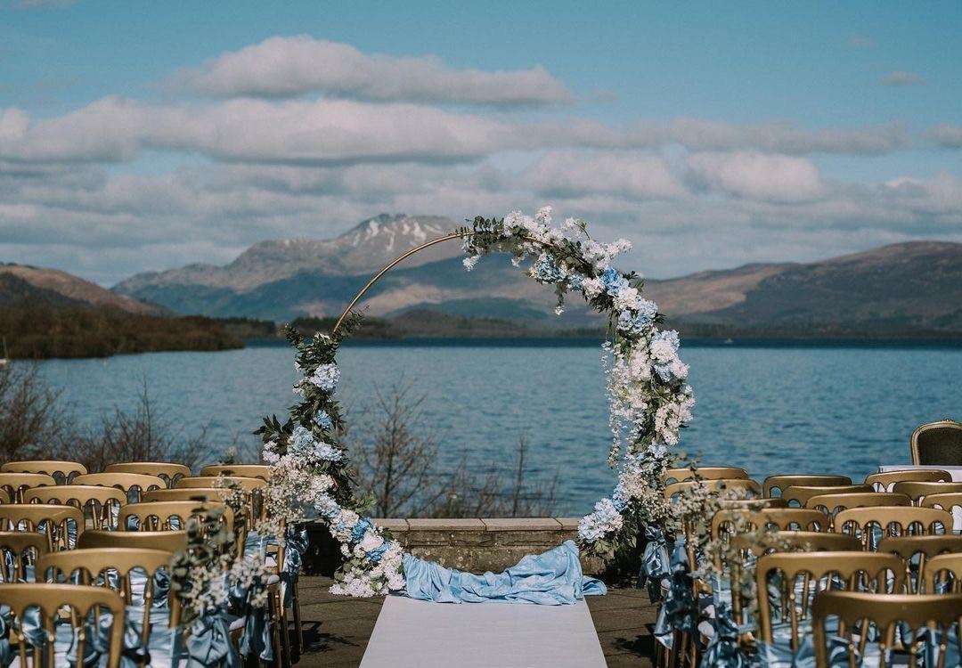 An outdoor ceremony set up by the waterside right next to Loch Lomond.