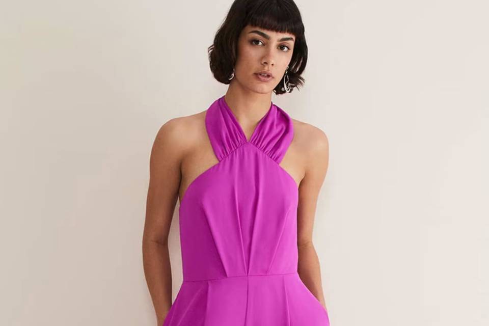 model wears purple mother of the bride alter neck outfit in bright pink