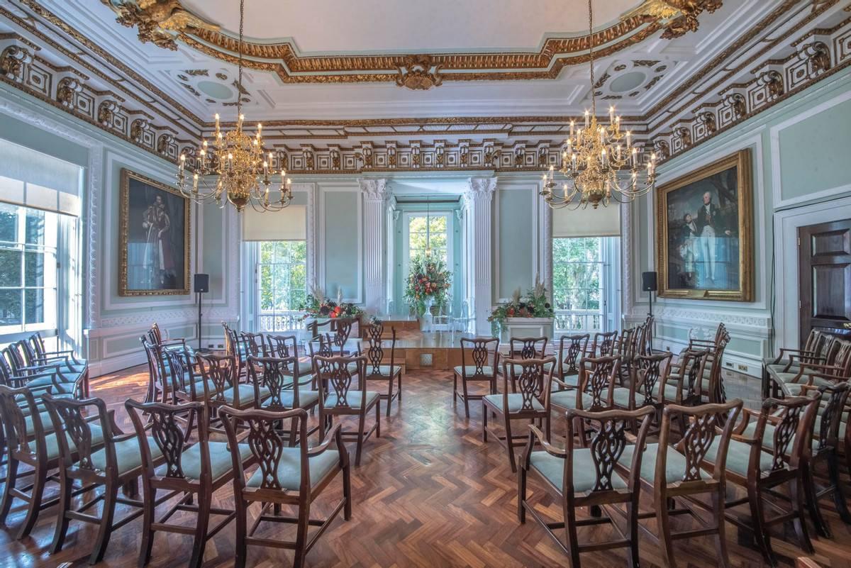 grand room with gold adorned ceilings and curtain rails