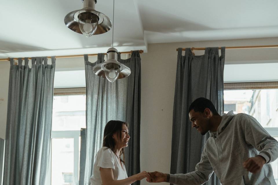 couple dancing in new home around cardboard boxes