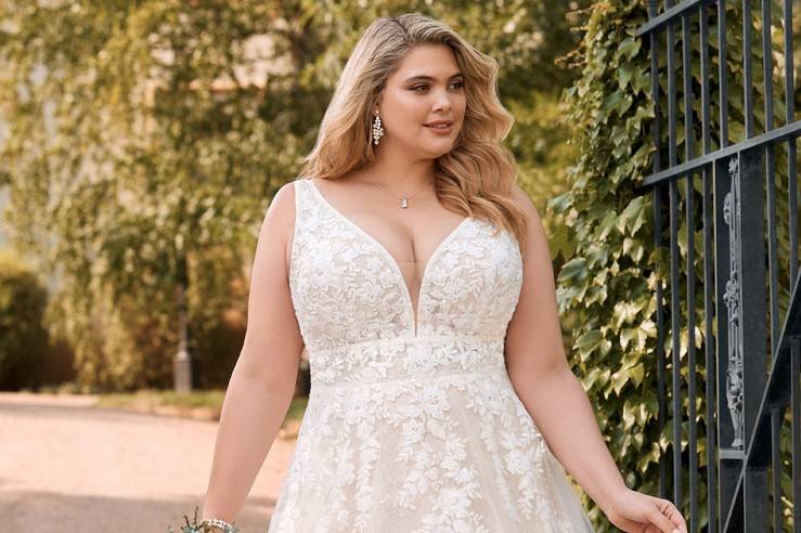 Model wearing a beaded plus size wedding dress from a plus size bridal boutique