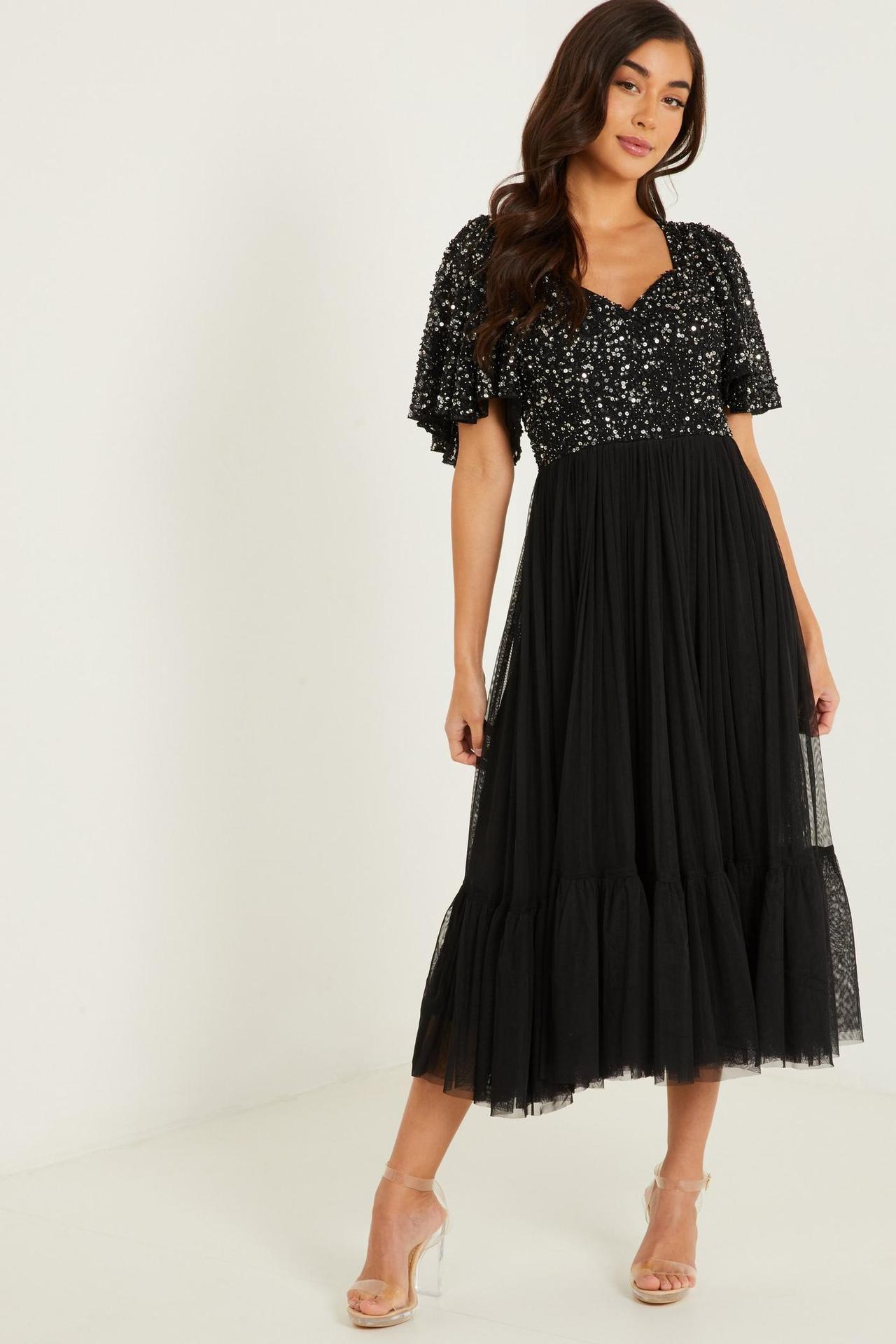 Model wearing a black sequin sweetheart neck bridesmaid dress