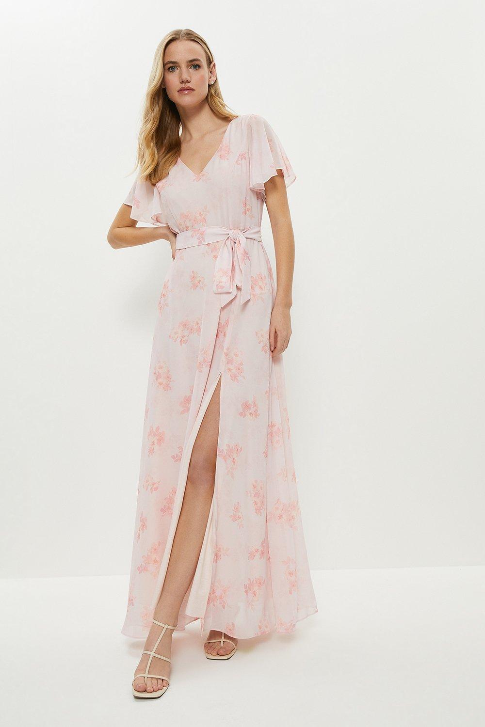 Model wearing a pink floral bridesmaid dress