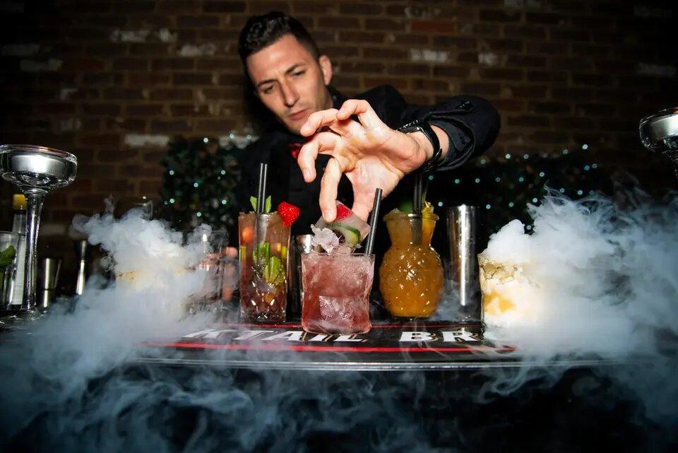 Bar man making unique cocktails 