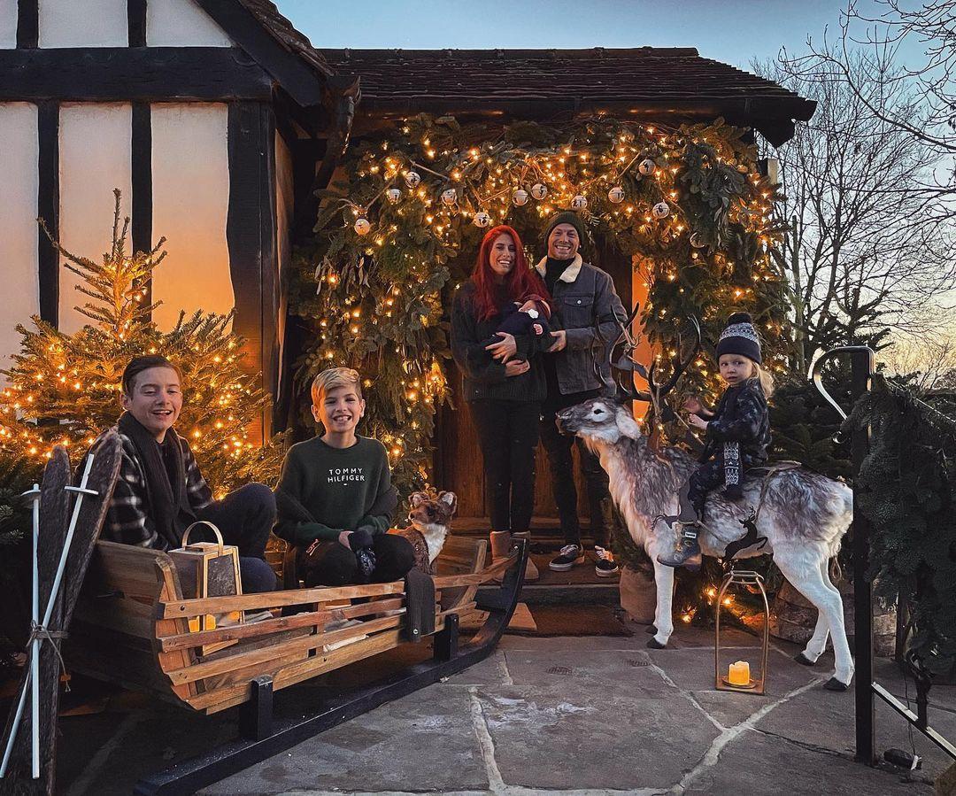 Stacey Solomon and Joe Swash with four of their children outside Pickle Cottage