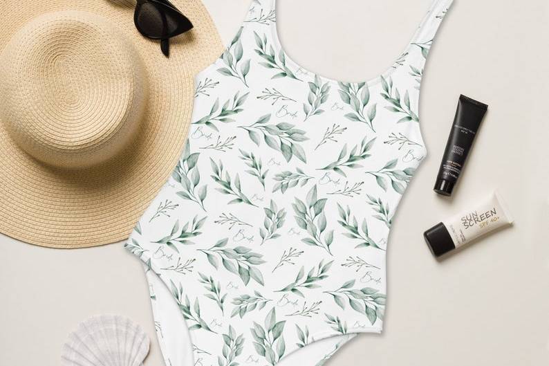 A eucalyptus pattern bikini next to a sun hat and sunglasses