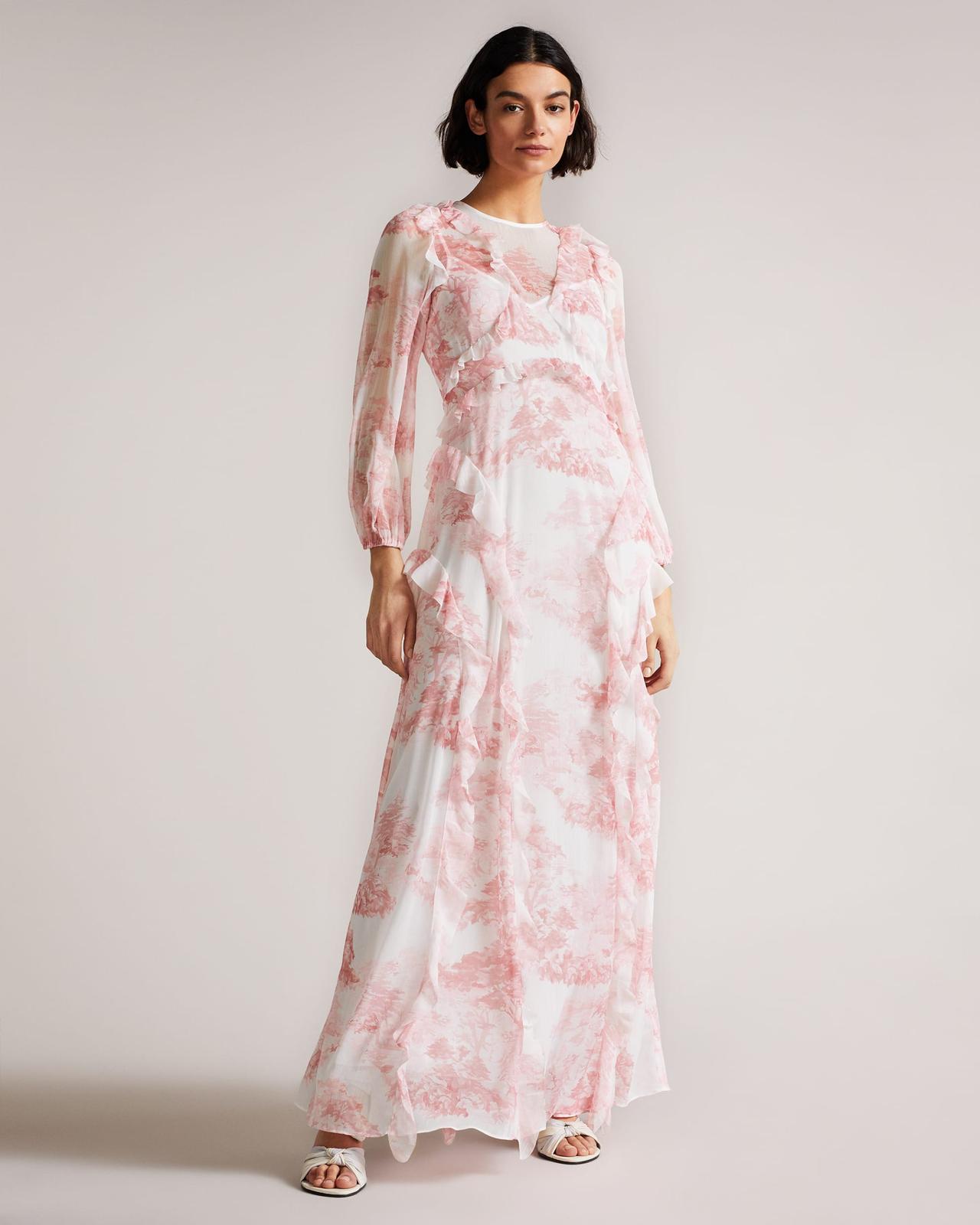 Image of a model wearing frill detail maxi dress in white and rose color