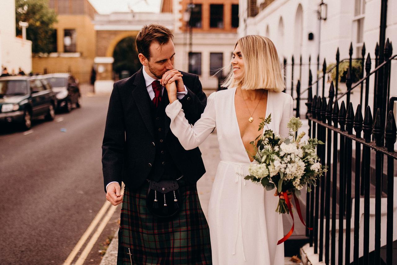 Groom kissing a bride's hand