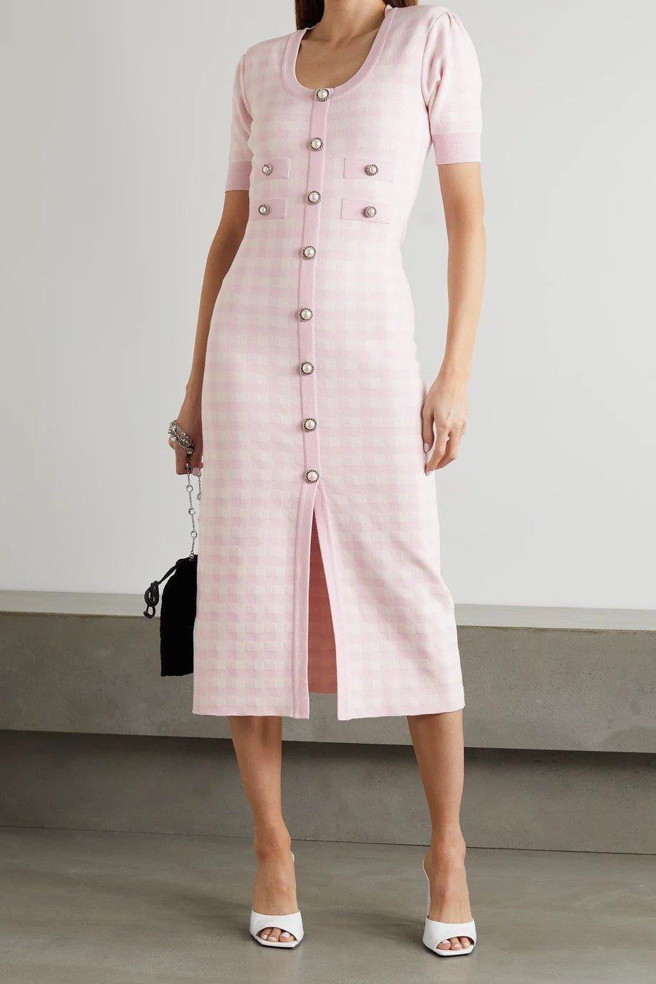 Model wearing a fitted pink gingham midi dress with pink buttons