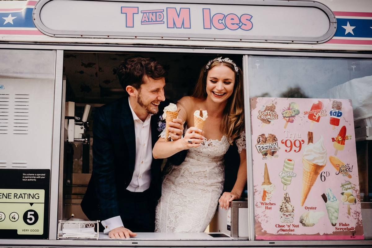 Bride and groom eating ice-cream out of an ice-cream van