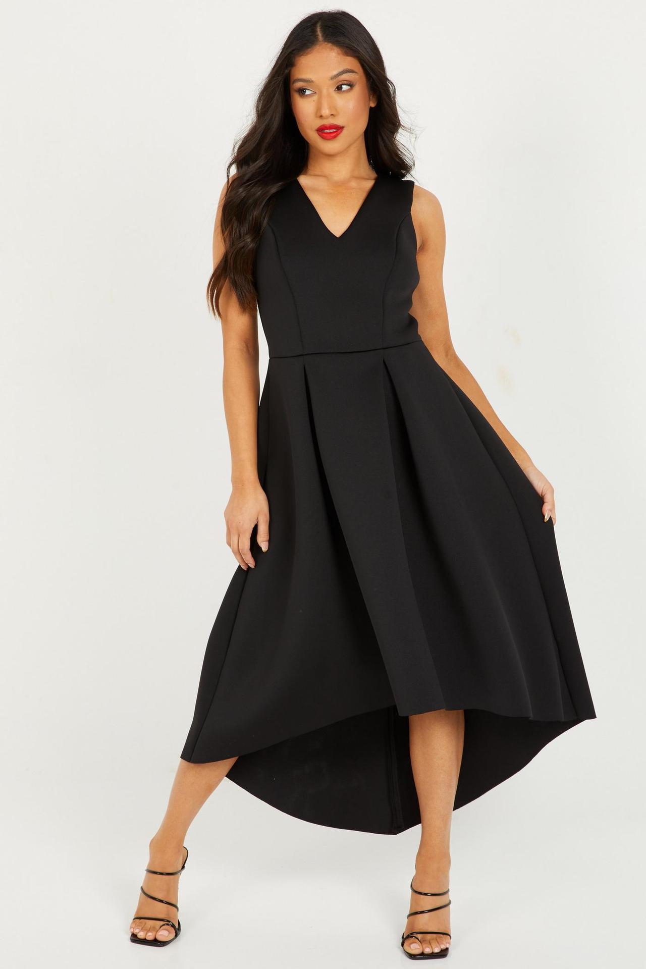 Model wearing a black dip hem dress