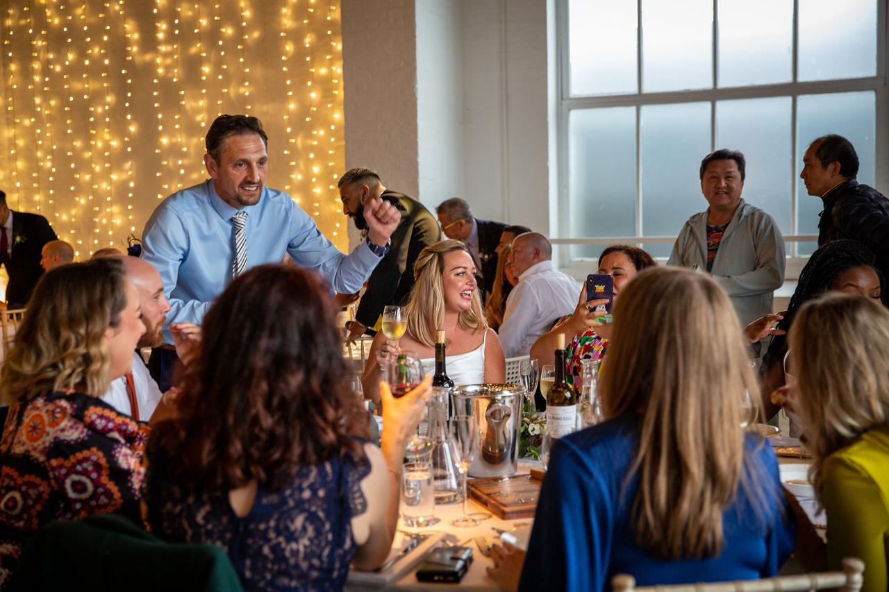 Wedding guests raise a glass and chat