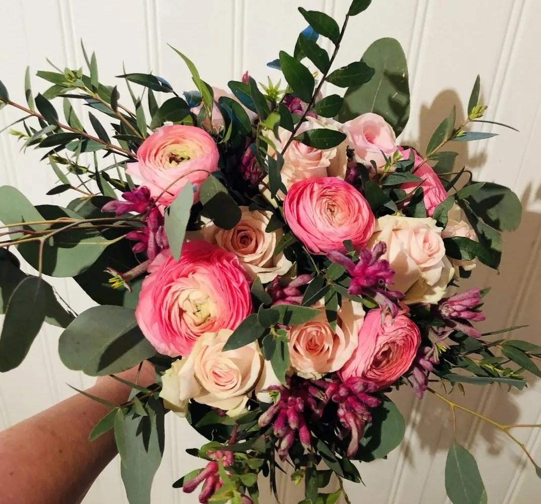 Pink rose and peony wedding bouquet with greenery