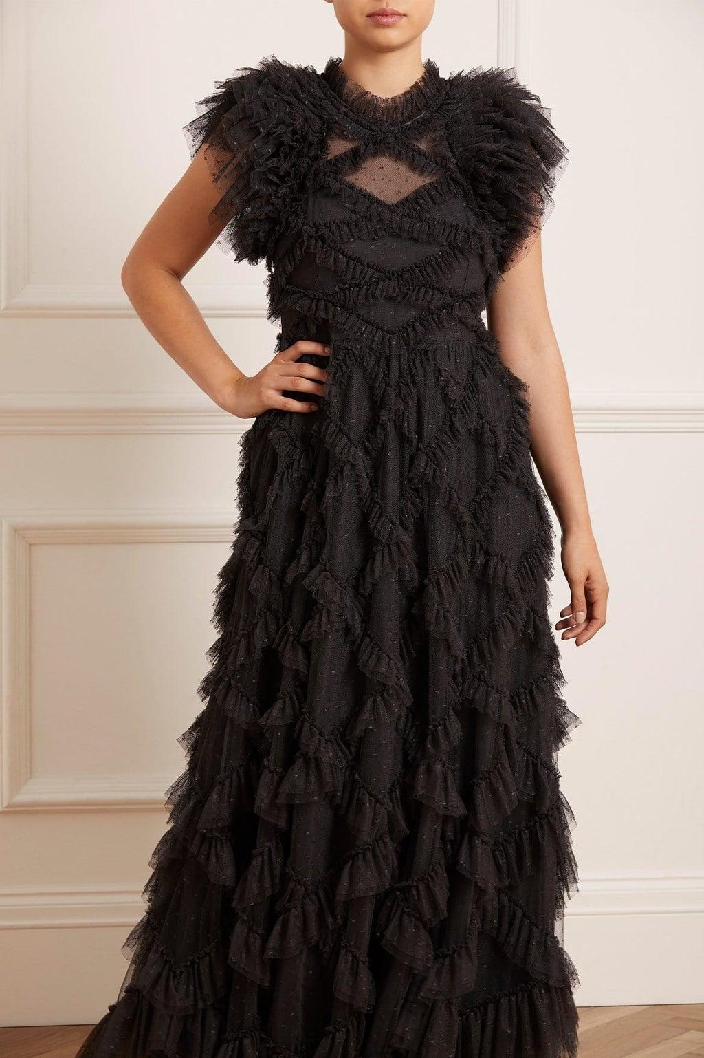 Model wearing a black ruffle gown