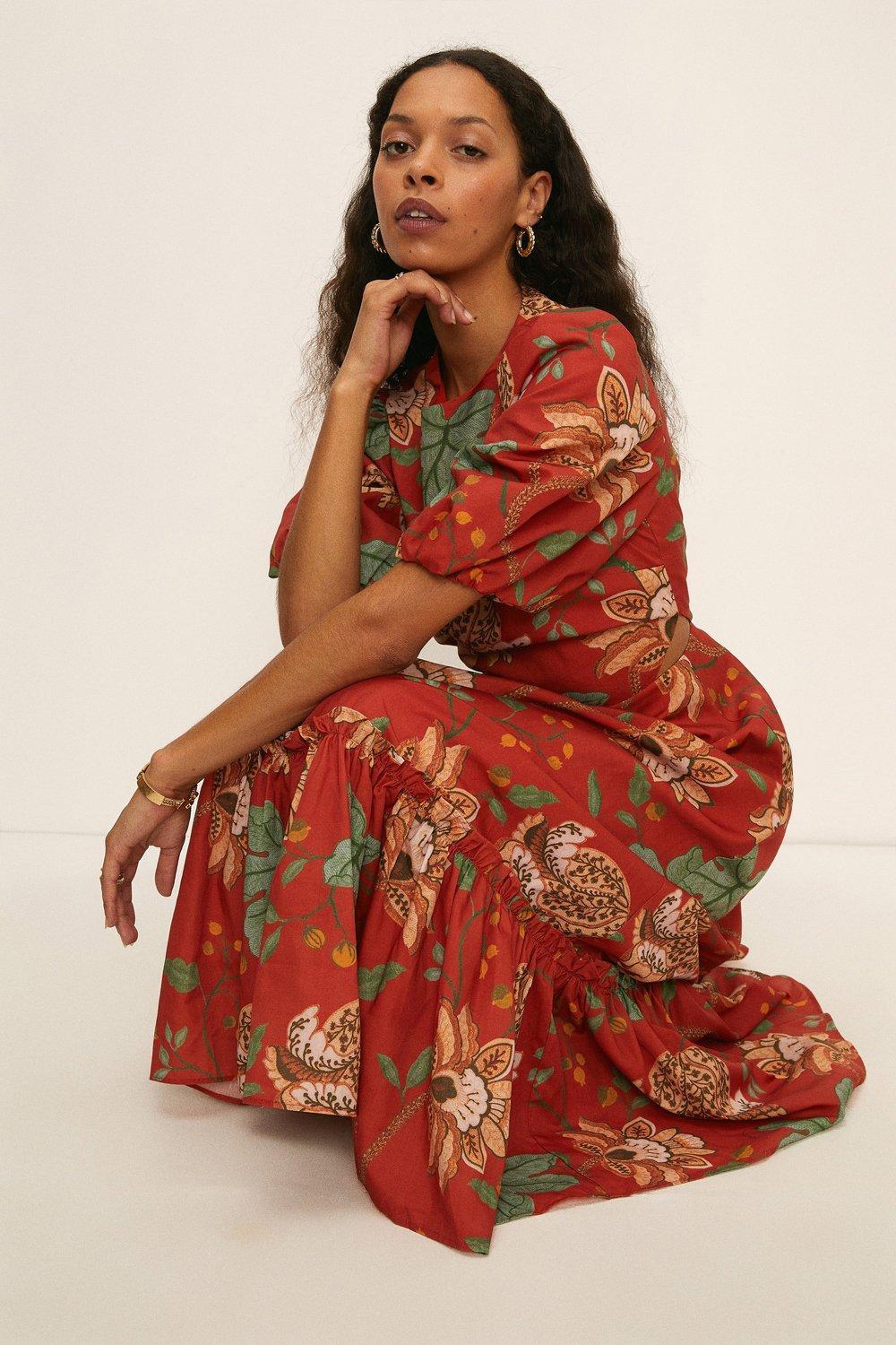 Model wearing an orange wedding guest dress