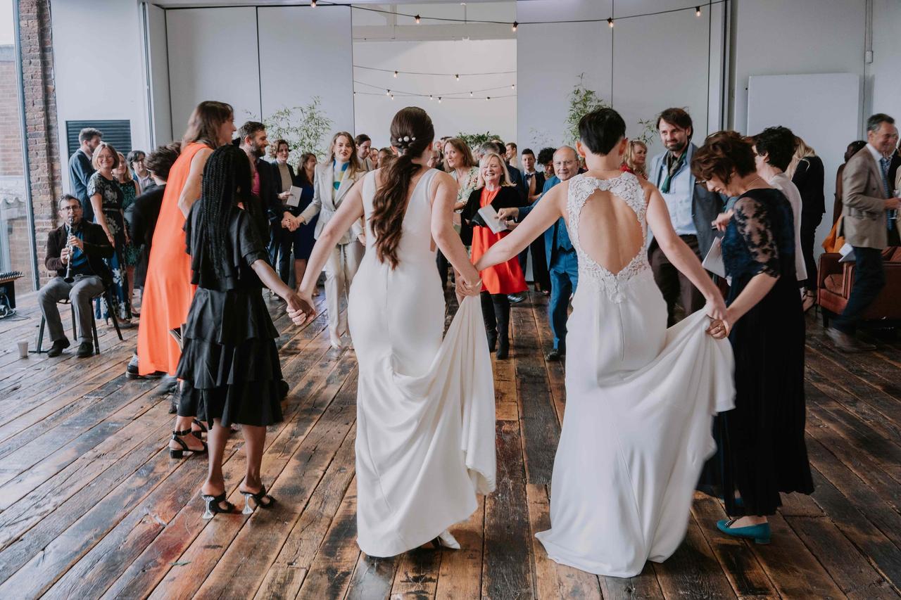 The brides dance with their guests
