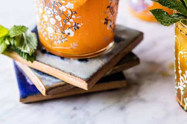 Orange drink in a patterned glass