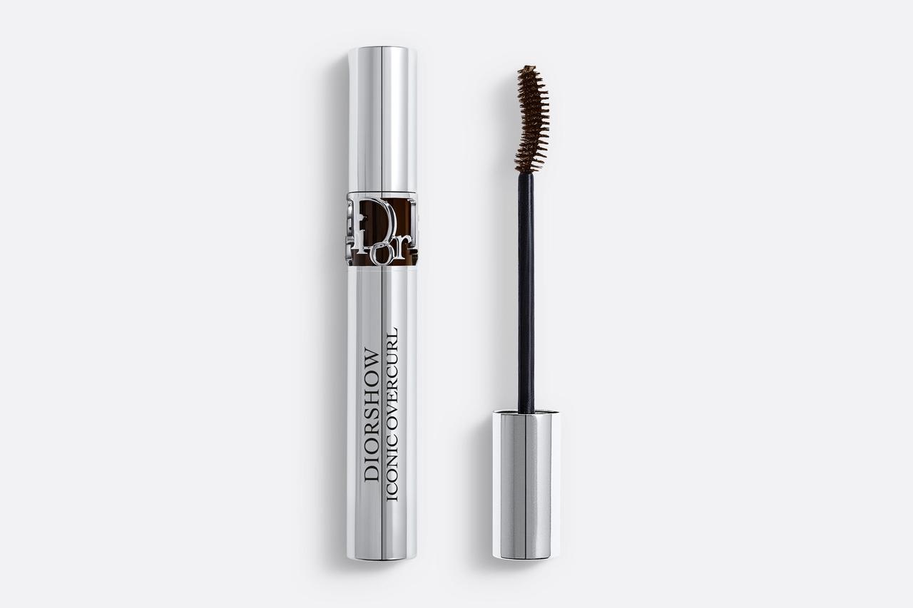 A silver tube of mascara with a curled wand